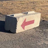 Image of an arrow on a binblockfor calling or filling out an order form on binblocks.net to place an order for concrete blocks.